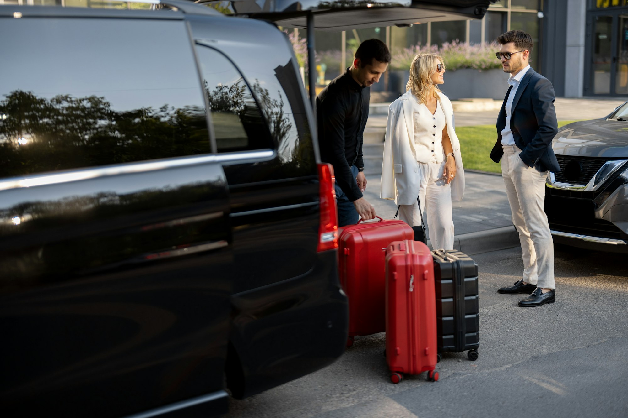 Chauffeur meeting a couple with luggage, Florence airport to train station transfer
