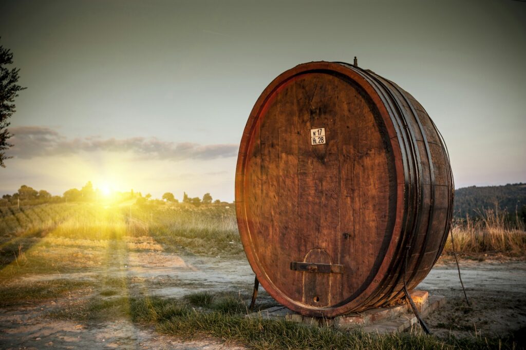 Wine in a wooden vat in southern Tuscany: how far is Montepulciano from Florence? About 1 h 20 min by car